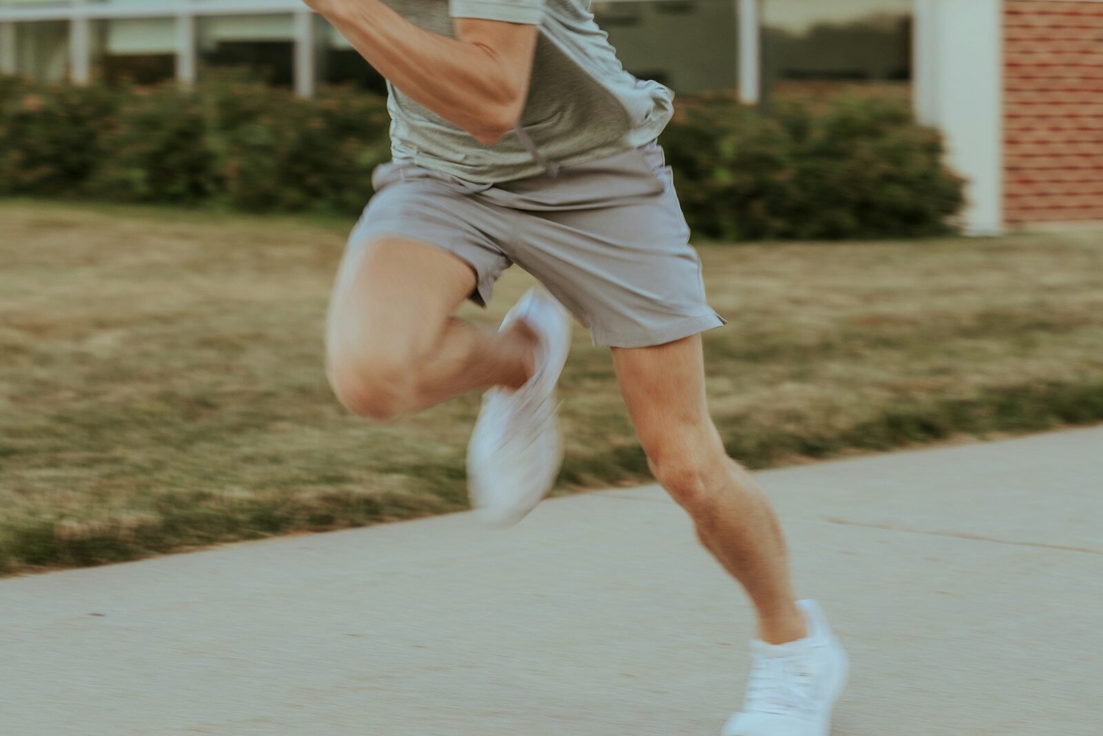 a man in grey shirt and shorts playing a game of tennis